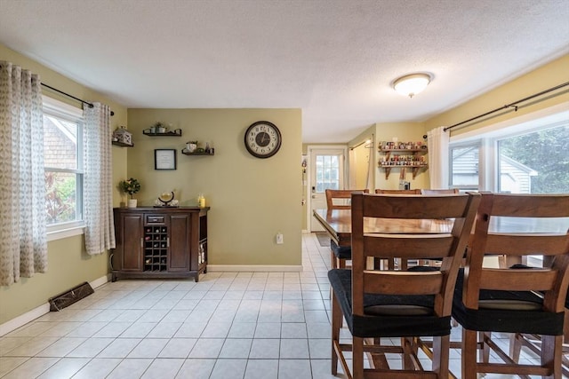 267 Maple St, East Longmeadow, MA 01028 - dining area featuring light tile patterned floors and a textured ceiling