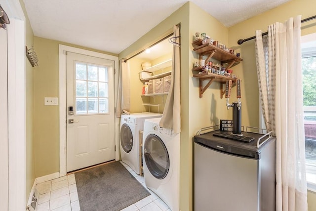 267 Maple St, East Longmeadow, MA 01028 - laundry area featuring washer and clothes dryer, light tile patterned floors, and healthy amount of natural light
