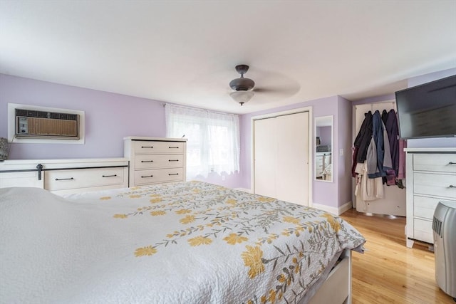 267 Maple St, East Longmeadow, MA 01028 - bedroom with light wood-style flooring, a closet, an AC wall unit, and a ceiling fan