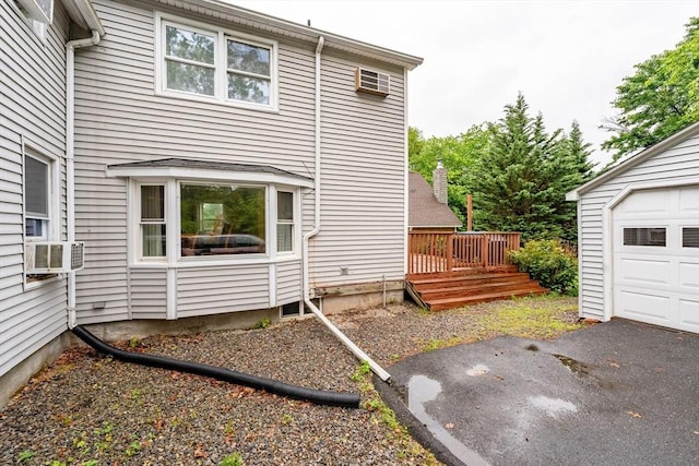 267 Maple St, East Longmeadow, MA 01028 - back of property featuring cooling unit, a garage, and a wooden deck