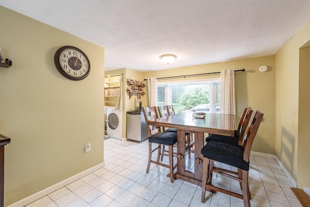 267 Maple St, East Longmeadow, MA 01028 - dining space with washer and clothes dryer, a textured ceiling, and light tile patterned floors