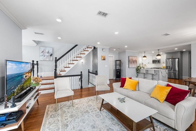 202 Middlesex Ave Unit 2, Medford, MA 02155 - living room featuring ornamental molding, stairs, recessed lighting, wood finished floors, and baseboards