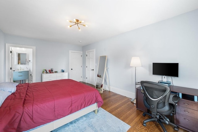 202 Middlesex Ave Unit 2, Medford, MA 02155 - bedroom with wood finished floors, baseboards, an office area, ensuite bathroom, and a sink