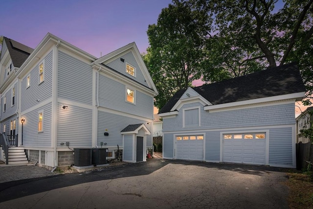 202 Middlesex Ave Unit 2, Medford, MA 02155 - view of side of property featuring an outbuilding, driveway, a garage, and cooling unit