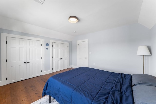 202 Middlesex Ave Unit 2, Medford, MA 02155 - bedroom featuring two closets, hardwood / wood-style floors, baseboards, and vaulted ceiling