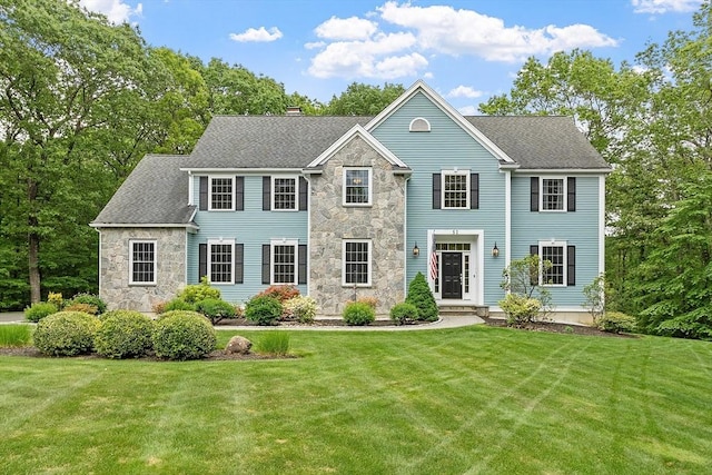 51 Drumlin Hill Rd, Bolton, MA 01740 - colonial home with stone siding, a front lawn, a chimney, and a shingled roof