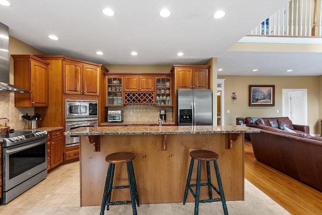 51 Drumlin Hill Rd, Bolton, MA 01740 - kitchen with stainless steel appliances, stone counters, a kitchen breakfast bar, glass insert cabinets, and brown cabinets