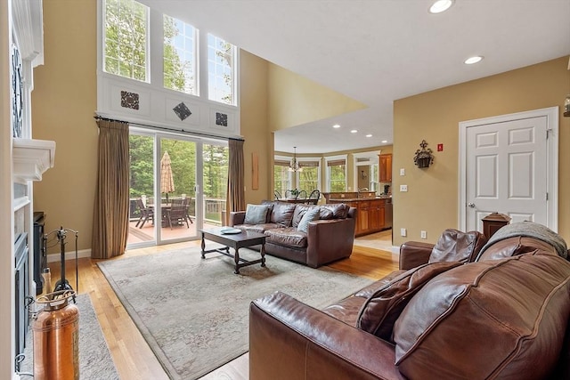 51 Drumlin Hill Rd, Bolton, MA 01740 - living room with a fireplace with flush hearth, light wood-style floors, a towering ceiling, recessed lighting, and baseboards