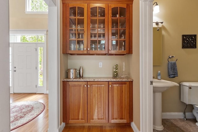 51 Drumlin Hill Rd, Bolton, MA 01740 - bar area with light wood-style floors, baseboards, and a sink