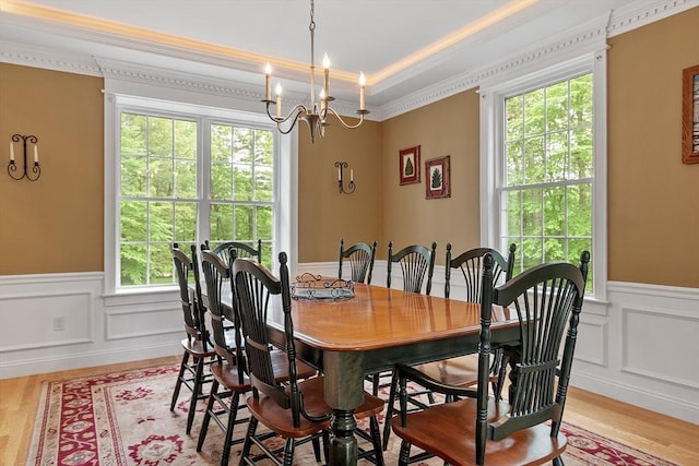 51 Drumlin Hill Rd, Bolton, MA 01740 - dining space featuring a chandelier, crown molding, light wood-style flooring, a wainscoted wall, and a decorative wall