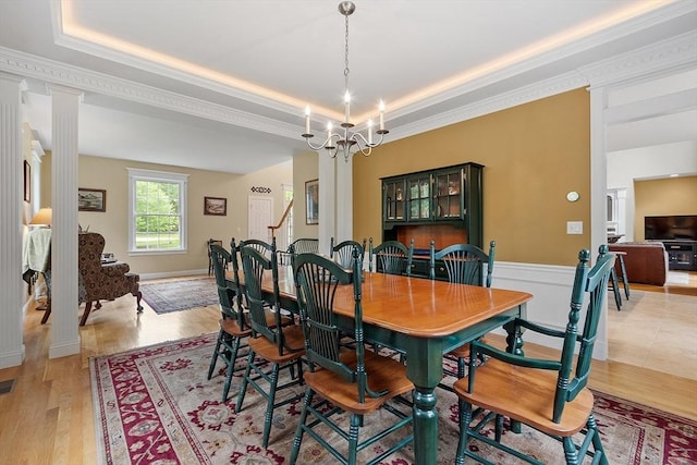 51 Drumlin Hill Rd, Bolton, MA 01740 - dining area with a tray ceiling, decorative columns, crown molding, light wood finished floors, and a chandelier