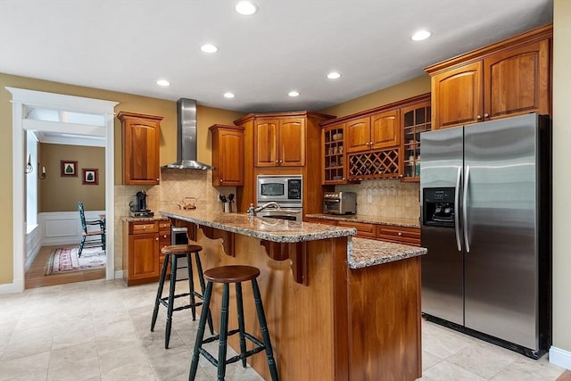 51 Drumlin Hill Rd, Bolton, MA 01740 - kitchen featuring stainless steel appliances, wall chimney exhaust hood, brown cabinets, recessed lighting, and glass insert cabinets