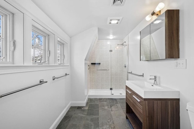 bathroom featuring toilet, a shower with door, and vanity