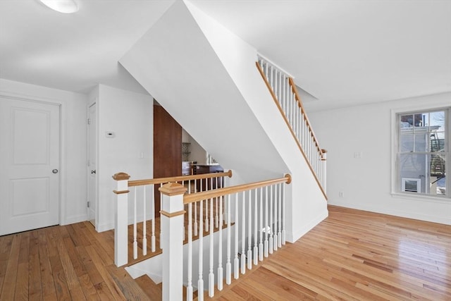 staircase with wood-type flooring