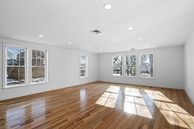 unfurnished living room with a wealth of natural light and light hardwood / wood-style floors