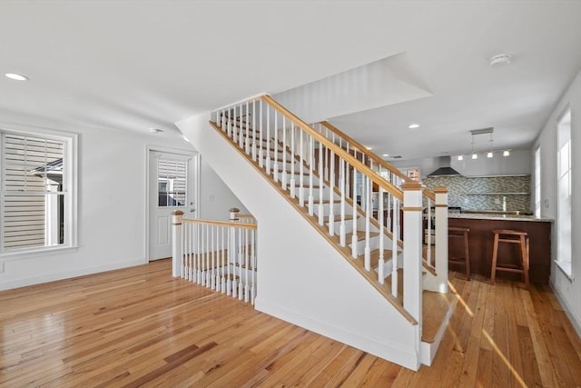 staircase with wood-type flooring