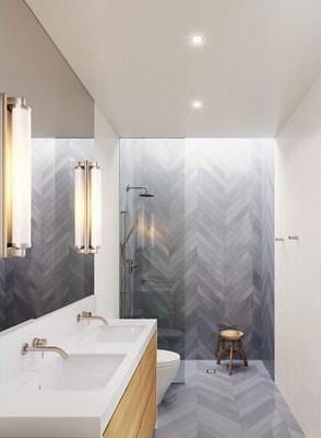 bathroom with tile walls, tiled shower, toilet, and vanity