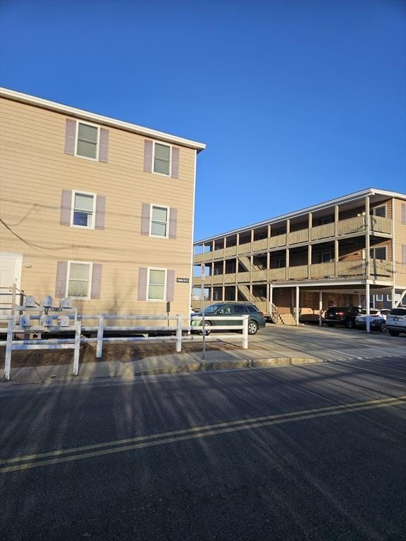 view of building exterior with uncovered parking