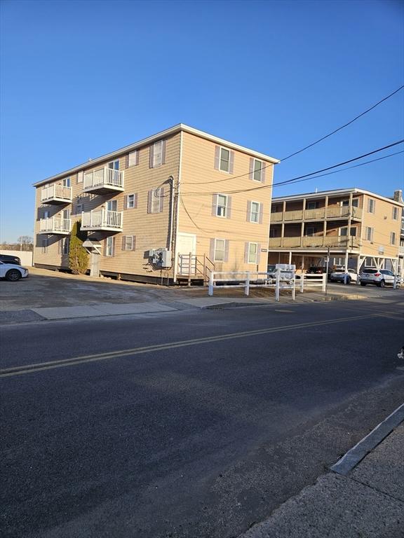 view of property featuring uncovered parking