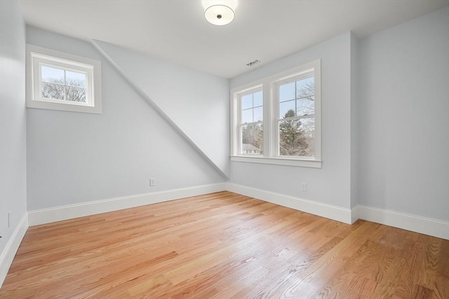 bonus room featuring a healthy amount of sunlight and light wood-type flooring