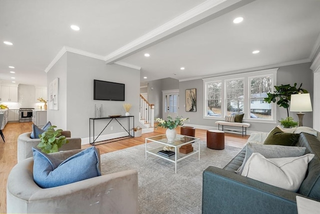 living room with light hardwood / wood-style floors and ornamental molding