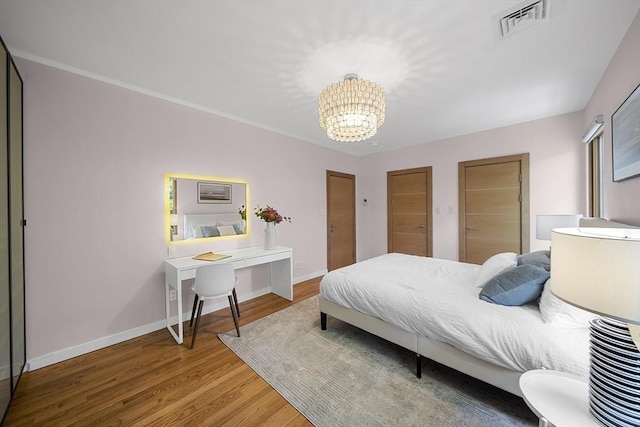 25 Day St, Newton, MA 02466 - bedroom featuring a chandelier, wood finished floors, and baseboards