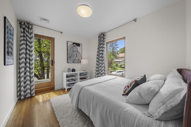 25 Day St, Newton, MA 02466 - bedroom featuring wood finished floors, baseboards, and access to exterior