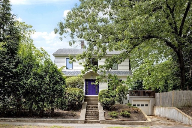 25 Day St, Newton, MA 02466 - view of front of home featuring driveway, a garage, stairs, a chimney, and roof with shingles