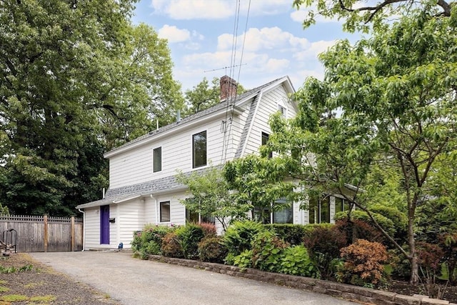 25 Day St, Newton, MA 02466 - dutch colonial featuring a chimney, driveway, and roof with shingles