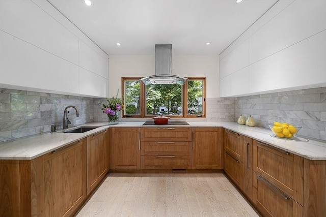25 Day St, Newton, MA 02466 - kitchen with a sink, island exhaust hood, black electric stovetop, light wood-type flooring, and brown cabinets