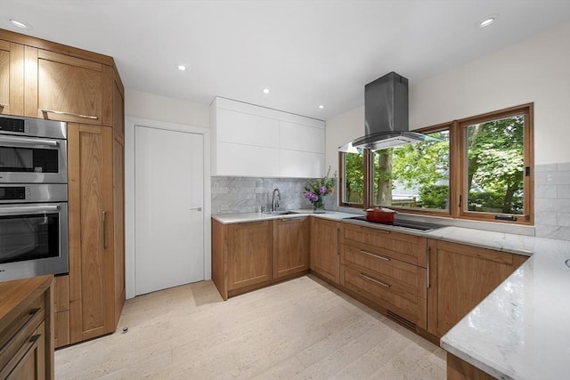 25 Day St, Newton, MA 02466 - kitchen with double oven, island exhaust hood, black electric cooktop, a sink, and brown cabinetry