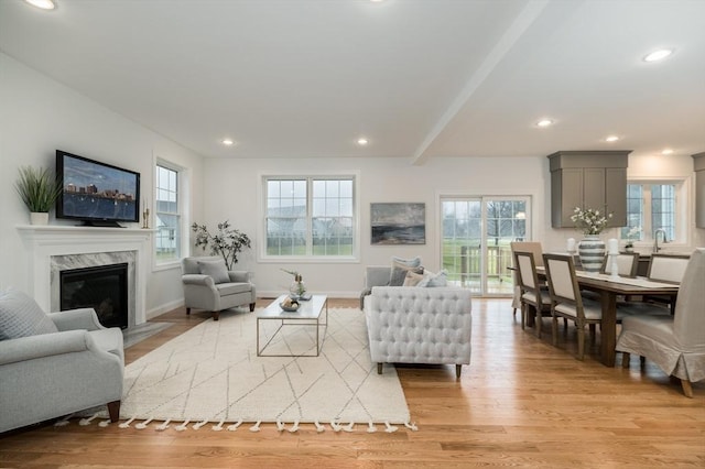 62 High St Lot 6, Stoneham, MA 02180 - living room with healthy amount of natural light, light wood finished floors, recessed lighting, a premium fireplace, and beam ceiling