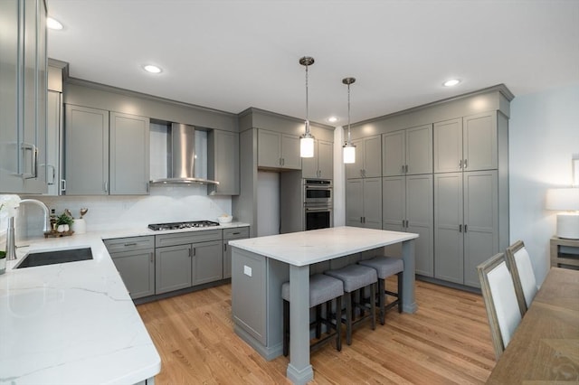 62 High St Lot 6, Stoneham, MA 02180 - kitchen featuring gray cabinets, a sink, wall chimney exhaust hood, light stone countertops, and stainless steel appliances