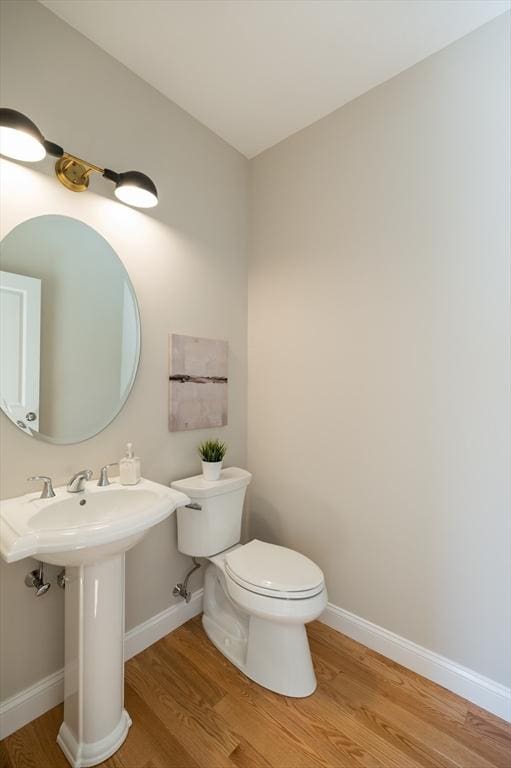 62 High St Lot 6, Stoneham, MA 02180 - half bath featuring wood finished floors, toilet, and baseboards