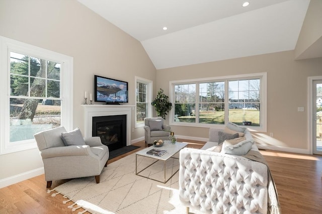 62 High St Lot 6, Stoneham, MA 02180 - living room featuring vaulted ceiling, wood finished floors, a fireplace with flush hearth, baseboards, and recessed lighting