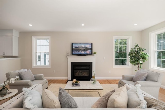62 High St Lot 6, Stoneham, MA 02180 - living room featuring light wood-style floors, recessed lighting, a glass covered fireplace, and baseboards