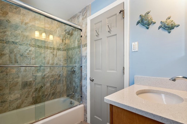 bathroom featuring enclosed tub / shower combo and vanity