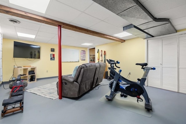 exercise room with a paneled ceiling