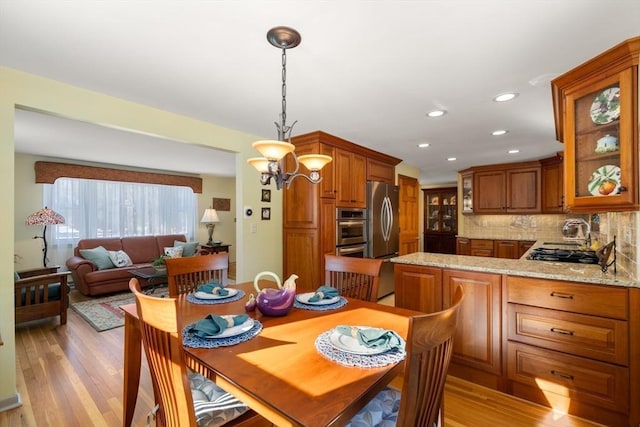 dining room featuring a notable chandelier and light hardwood / wood-style flooring