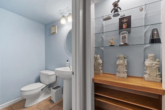 bathroom featuring sink, tile patterned floors, and toilet