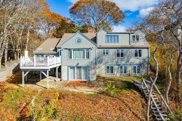 rear view of house featuring a wooden deck