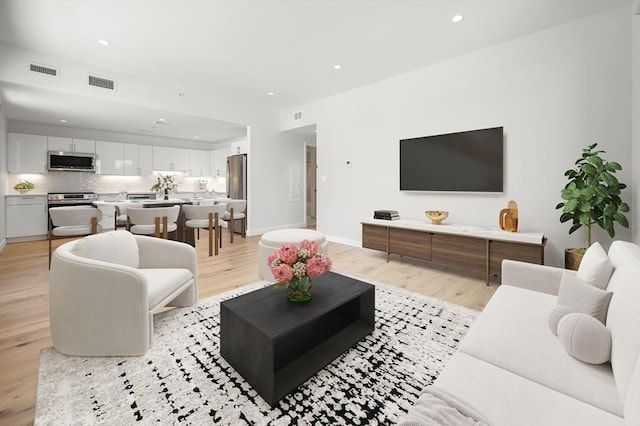 2149 Washington St Unit 604, Boston, MA 02119 - living area featuring light wood-style floors, recessed lighting, and baseboards
