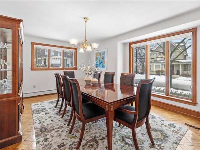 dining area with a chandelier, a baseboard radiator, visible vents, and baseboards