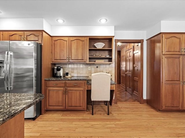 kitchen with light wood-style floors, brown cabinetry, and stainless steel fridge with ice dispenser