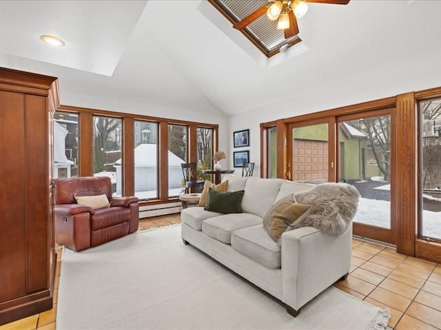 living area with lofted ceiling with skylight, baseboard heating, light tile patterned flooring, and a ceiling fan