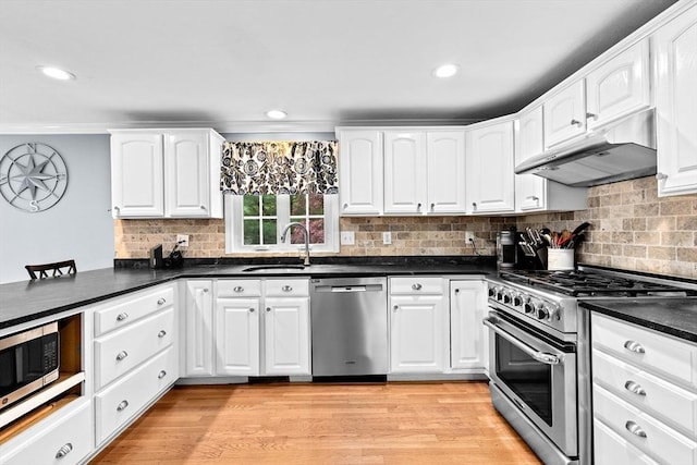 16 Old Colony Way, Whitman, MA 02382 - kitchen with stainless steel appliances, a sink, under cabinet range hood, dark countertops, and white cabinetry