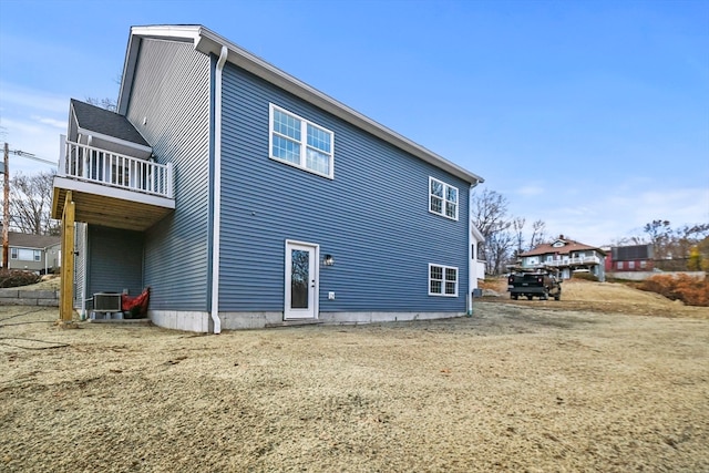 back of house with a balcony and cooling unit