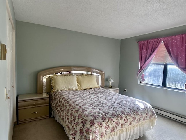 carpeted bedroom with a baseboard radiator and a textured ceiling