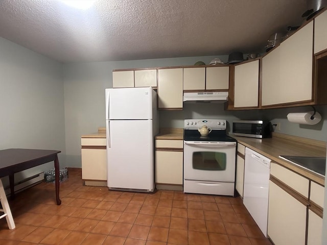 kitchen featuring white appliances, sink, and a textured ceiling