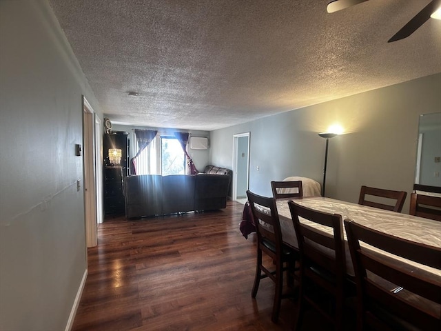 dining area featuring ceiling fan, a wall mounted air conditioner, a textured ceiling, and dark hardwood / wood-style flooring